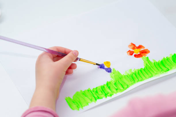istock Child is drawing flowers 1225523167