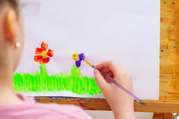 istock Child is drawing flowers on paper. 1225523428