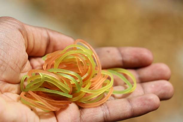 rubberband which is an stationary product used to bind object since its flexible - flexibility rubber rubber band tangled imagens e fotografias de stock