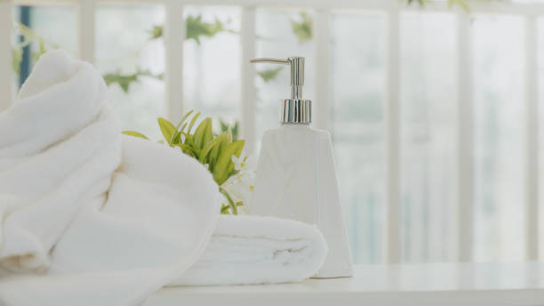 istock Shampoo and shower cream bottle with towel 1225527817