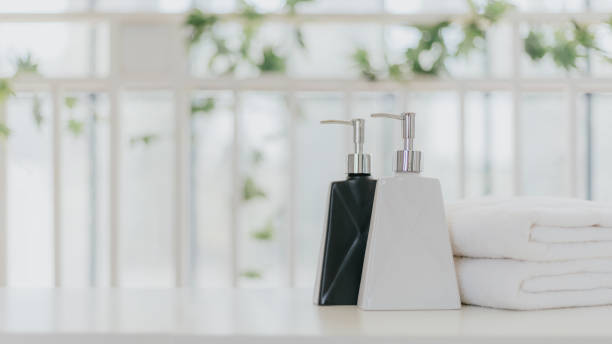 istock Shampoo and shower cream bottle with towel 1225527828