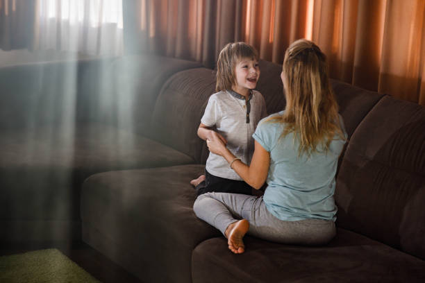 istock Happy boy talking to his single mother at home. 1225531036
