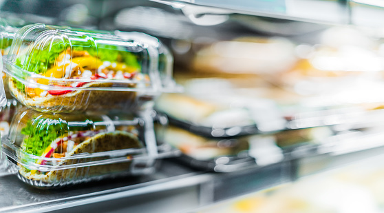 Chilli chicken with pita, pre-packaged sandwiches displayed in a commercial refrigerator