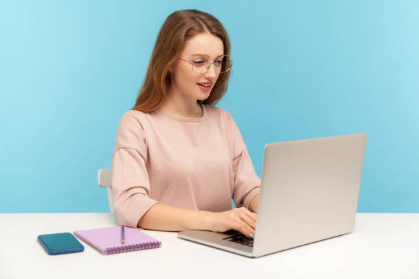 istock Smart woman in nerd eyeglasses typing on laptop, working with clever diligent expression in office. Student studying 1225534150