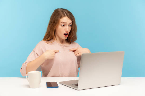 istock This is me! Surprised woman employee pointing herself and looking with amazed expression, talking on video call 1225534152