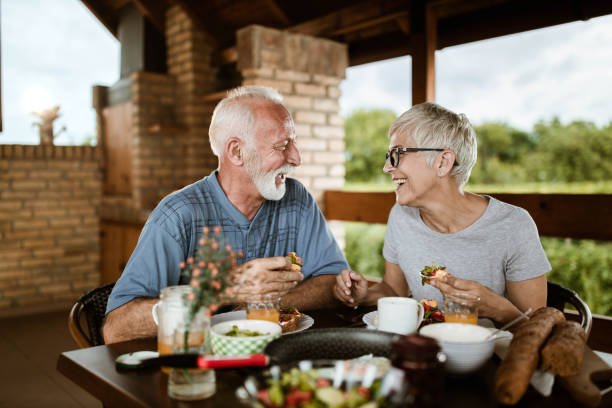 istock Happy mature couple talking while having breakfast on a balcony. 1225535081