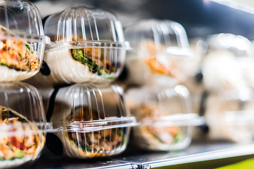 Pre-packaged sandwiches displayed in a commercial refrigerator