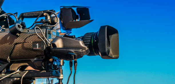 istock Professional tv camera on tripod recording social event 1225535118