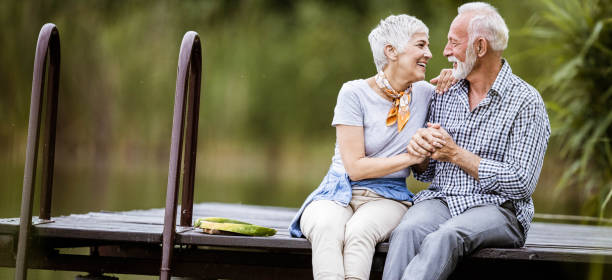 istock Panoramic view of happy senior couple talking while enjoying on a pier. 1225535194
