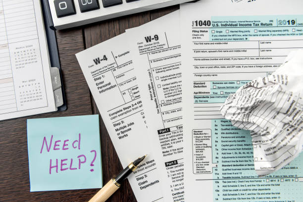 istock Federal 1040 tax form with sticker, calculator and pen 1225536631