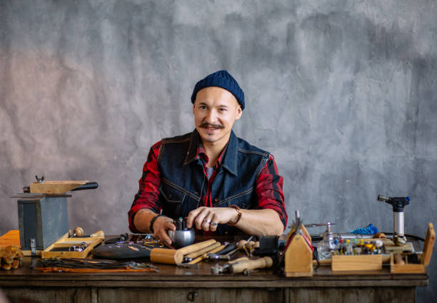 istock positive attractive man creating a design while working in the jewelry shop 1225536938