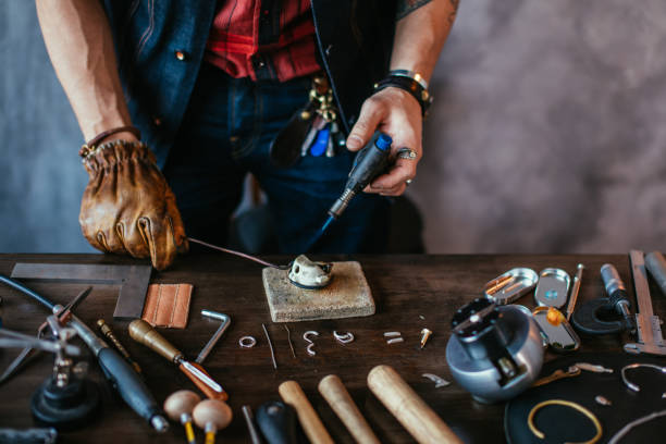 istock man in gloves melting silver to make jewelry 1225536977