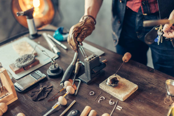 istock man putting heated metal on the table 1225537736