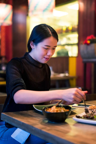 istock Female having a meal in Thai restaurant 1225538252