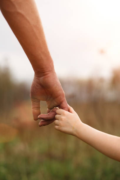istock A small child's hand in his father's big palm. 1225538628