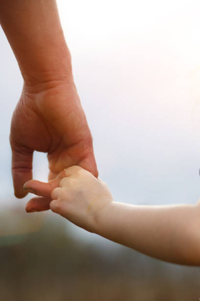 istock A small child's hand in his father's big palm. 1225538639