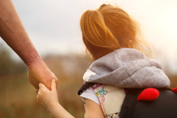 istock A small child's hand in his father's big palm. 1225538640