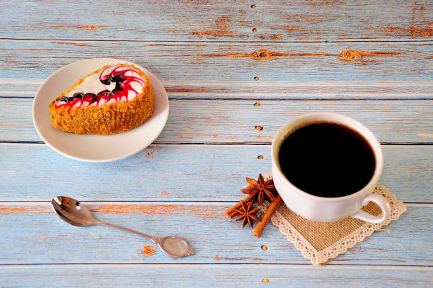 istock A cup of black coffee and a dragon biscuit cake on a white ceramic plate. 1225538942