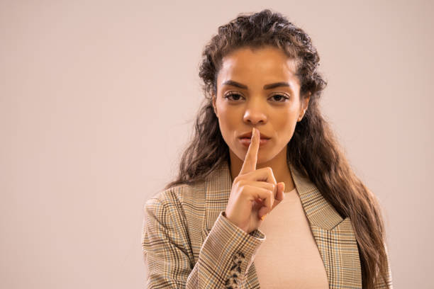 african-american businesswoman portrait - silence finger on lips businesswoman one person imagens e fotografias de stock