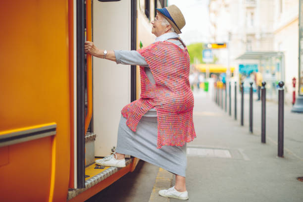 istock Senior woman is getting on the tram 1225541657