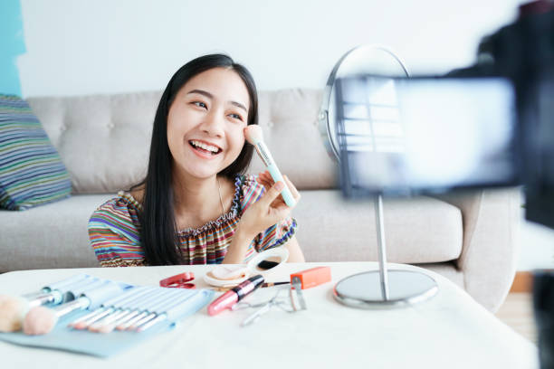 istock Beauty blogger of Asian female tutorial makeup cosmetics live broadcasts video streaming. Beautiful influencers are recommending using cheek brushes for beauty. concept online learning 1225542497
