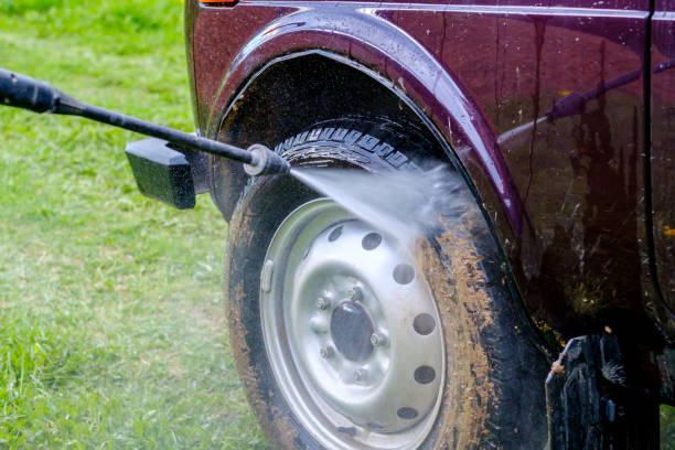 car wash in the afternoon outdoors with a high-pressure apparatus. - sports utility vehicle 4x4 car tire imagens e fotografias de stock