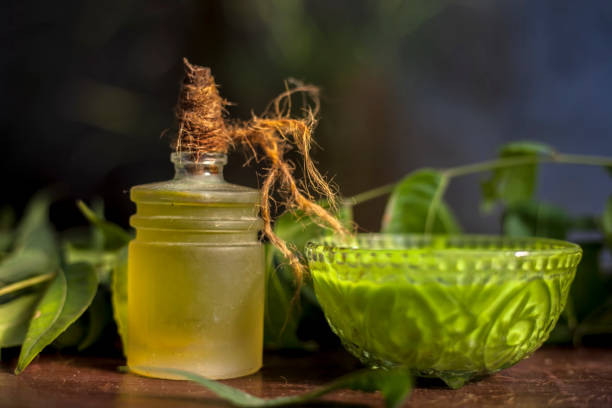 istock All scalp related problems solution lotion or shampoo in a glass bowl consisting of some neem leaves, fenugreek seeds and olive oil. Shot of fresh leaves of Neem tree,fenugreek seeds,pack,& olive oil. 1225544226