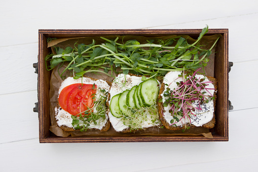 What Is Vegan Cream Cheese? Plus, Your Guide to the Best Dairy-Free Brands What Is Vegan Cream Cheese? Plus, Your Guide to the Best Dairy-Free Brands healthy sandwiches with cream cheese microgreens tomatoes and cucumber in wooden box healthy