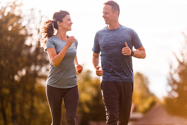 istock Happy athletic couple talking and running in nature. 1225544769