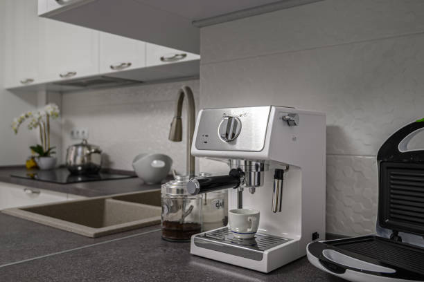 istock Espresso coffee maker in minimalistic white kitchen interior 1225545061