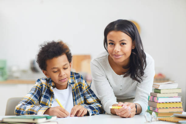 istock African Boy Studying at Home with Mother 1225545067