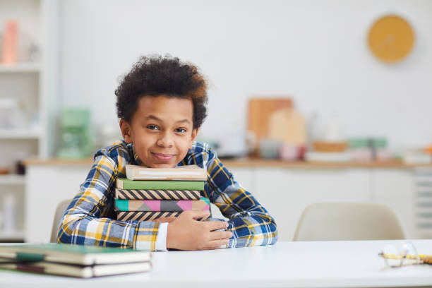 istock Cute African Boy Posing with Books 1225545072