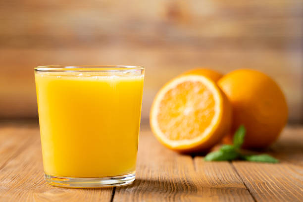 Shot of Fresh Orange Juice in a Glass Shot of Fresh Orange Juice in a Glass orange juice stock pictures, royalty-free photos & images