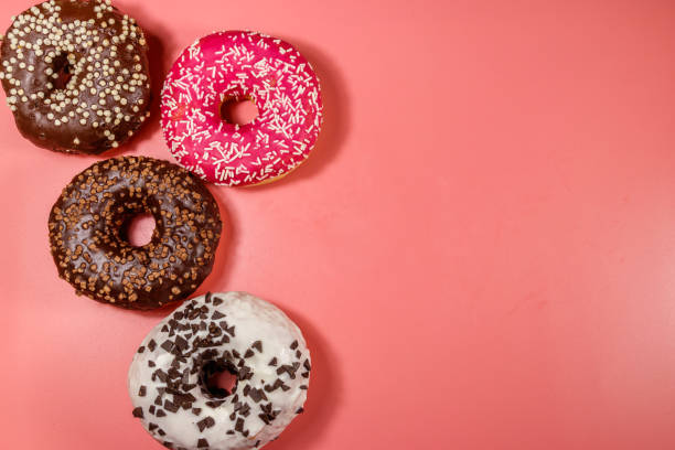 istock Tasty donuts on pink background. Top view, copy space 1225546409