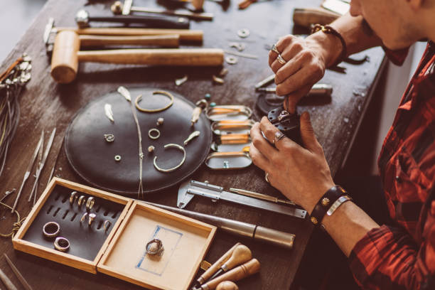 istock man cleaning the jewellery for client 1225546767