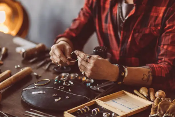 Photo of Jeweler working with chain in the workshop