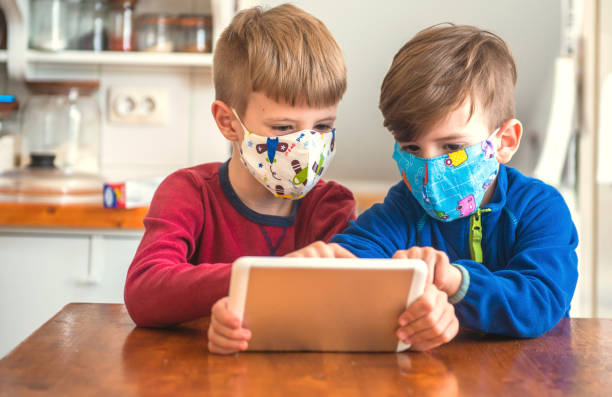istock Boys Playing With Digital Tablet At Home 1225547710