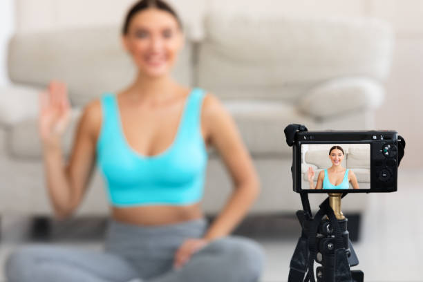 istock Yoga Instructor Making Video Yoga Training For Blog At Home 1225550078
