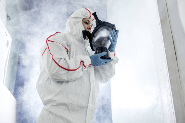 istock disinfector in protective suit conducts disinfection 1225550117