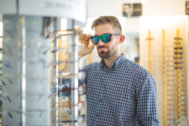 istock Young man buying sunglasses at the optical store 1225550123