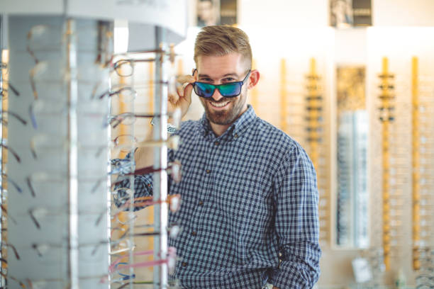 istock Young man buying sunglasses at the optical store 1225550222