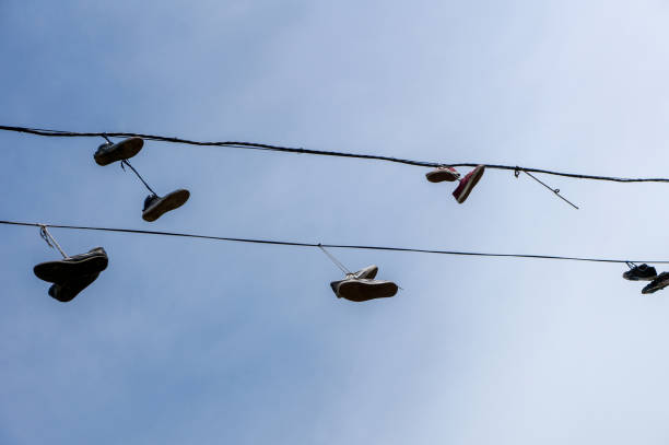 istock silhouettes of shoes hanging 1225550384