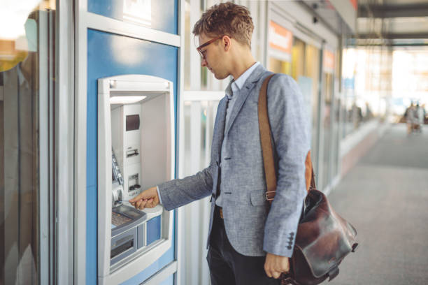 istock Man is withdrawing cash from an atm machine 1225550615