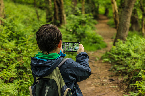 A child taking photos on a country footpath