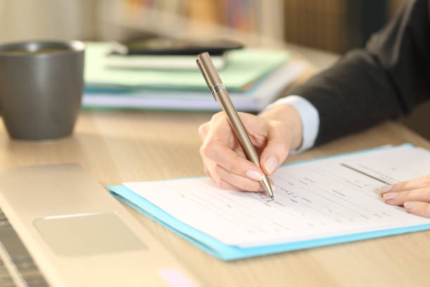istock Entrepreneur hands filling checkbox form at home 1225552135