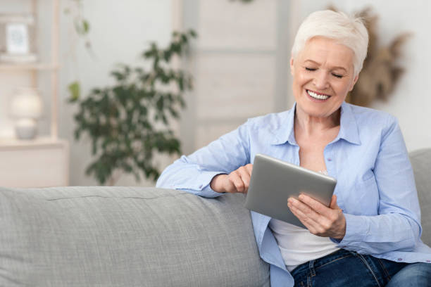 istock Retirement Leisure. Smiling Elderly Woman Resting With Digital Tablet At Home 1225552143