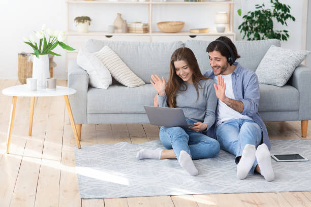 istock Cheery young couple having video call with friends 1225552402