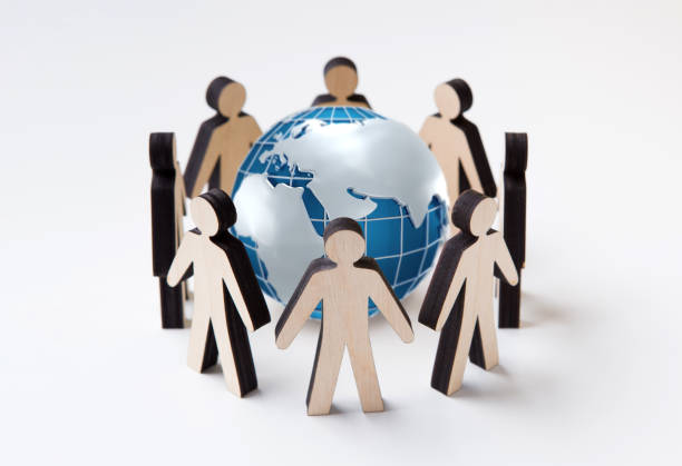 istock Protect Earth concept. Wooden people figures standing in circle around globe, white background. Collage 1225553043