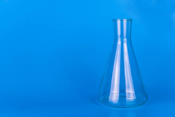 istock Medical laboratory flask on a blue background. Copy space. 1225553053