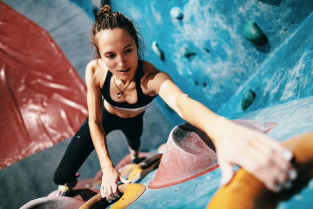 istock High angle view of strong woman on boulder climbing 1225553167